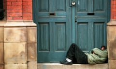Homeless man sleeping in a doorway