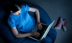 Woman on laptop on sofa