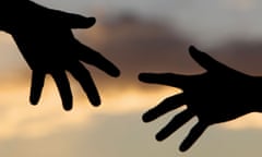 Silhouette of two hands reaching out towards each other