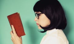 Profile of a young woman reading a book.