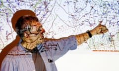 Meteorologist points to a weather map