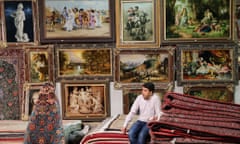 An Iranian vendor waits for clients at Iran's international hand-woven carpet exhibition in Tehran.