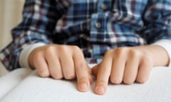 A person reading by Braille