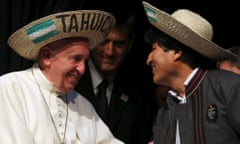 Pope Francis is greeted by Bolivian President Evo Morales after receiving a typical sombrero during a World Meeting of Popular Movements in Santa Cruz, Bolivia, July 9, 2015. The word "Tahuichi" is from the Tupi-Guarani and means "Big Bird". REUTERS/Alessandro Bianchi:rel:d:bm:GF10000154382