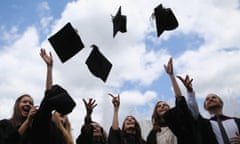 Students throw their caps in the air ahead of their graduation ceremony at the Royal Festival Hall.