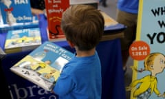 A boy holds his new copy of Dr Seuss's What Pet Should I Get? at a San Diego bookshop.