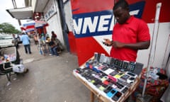 Liberian mobile phone dealers showcase their products in Monrovia. Millions of new consumers are accessing insurance through mobile platforms.