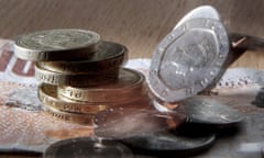 coins and note in a pile