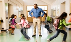 Teacher with students running around him