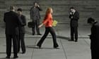 Young woman walking through business people