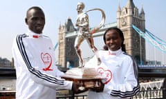 Running the show ... Emmanuel Mutai and Mary Keitany with the London Marathon trophy.