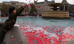 Cadet throwing poppies int fountain