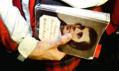 Man with kilt and book of Robert Burns' poetry