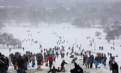 Crowds of people enjoy the snow in Primrose Hill, London.