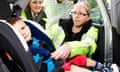 A child seat safety officer helps fit a car seat