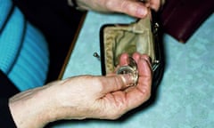A woman counting coins from her purse