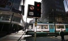 A Metrolink tram moves through the centre of Manchester. Photograph: Christopher Thomond