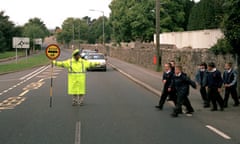 LOLLIPOP LADY AT PEDESTRIAN CROSSING, BRITAIN