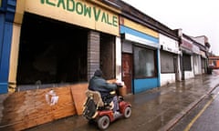 Man on mobility vehicle in rundown area