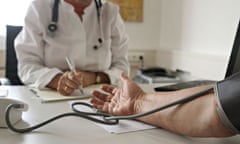 Doctor takes patient's blood pressure