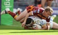 Warrington's Vinnie Anderson dives over to score a try despite the tackle from Brett Hodgson