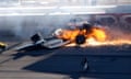 Drivers Dan Wheldon, front, and Will Power crash at the Las Vegas Motor Speedway