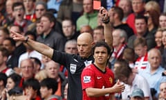 Manchester United's Rafael Da Silva is shown a red card by referee Howard Webb