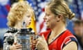 Kim Clijsters carries daughter Jada while holding the US Open trophy