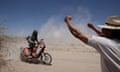 A spectator cheers as Frank Verhoestraete goes past at the Dakar Rally 2010
