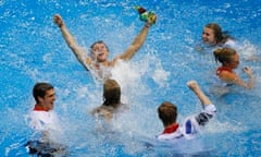 Tom Daley celebrates his bronze medal with team-mates by jumping into the pool at Aquatics Centre
