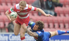 Sam Tomkins is tackled by Ben Cockayne