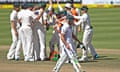 Faf du Plessis walks to the pavillion as the Australia players celebrate