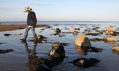 Kevin's daughter Maddy walking in the rockpools on Rigg Sands, Galloway, Scotland.