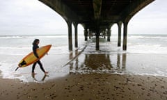 A surfer at Boscombe Beach near Bournemouth, DOrset