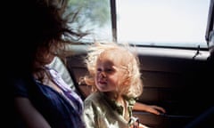 A Mom Holds Her Son In The Back Of A Cab While On Vacation.