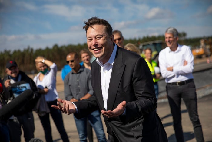 Tesla head Elon Musk talks to the press as he arrives to to have a look at the construction site of the new Tesla Gigafactory near Berlin