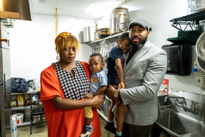 Two Atlanta CloudKitchens operators, Anita and Chudi Orubele,hold their children