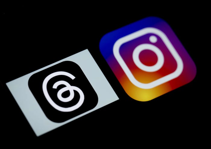 The logo of Threads is displayed on a mobile phone screen in front of a computer screen displaying the logo of Instagram in Ankara, Turkiye on July 04, 2023.