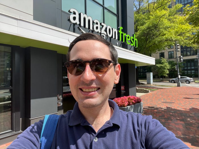 Insider reporter Alex Bitter stands outside an Amazon Fresh grocery store in Maryland.