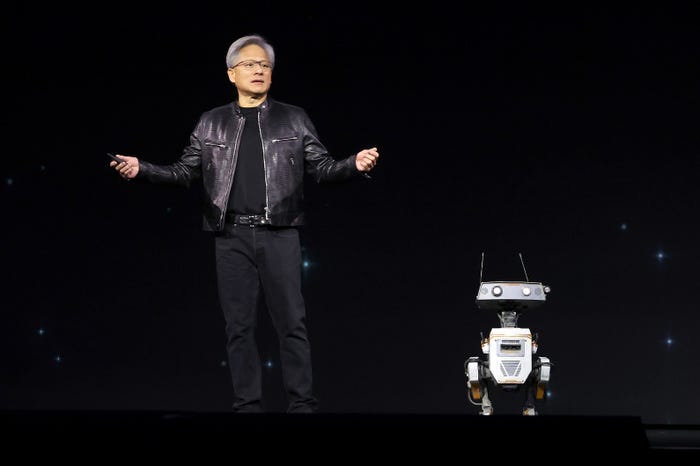 Jensen Huang onstage next to a small robot.