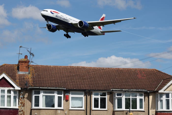 A Boeing 777-236(ER) comes in over the rooftops of residential houses, to land at Heathrow Airport in west London on April 29, 2024.