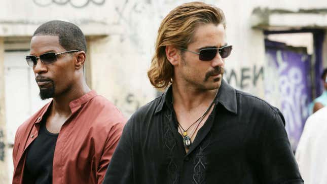 Jamie Fox and Colin Farrell look off-camera while wearing sunglasses.