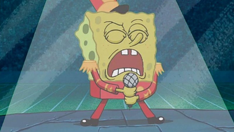 Spongebob in a red costume singing passionately into a mic