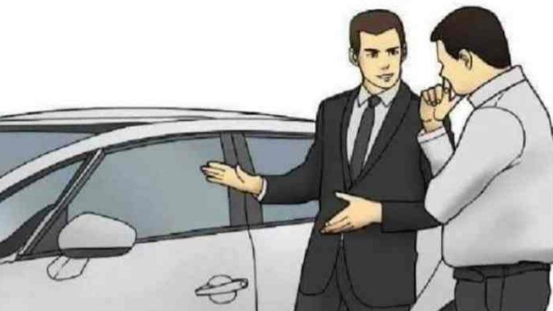 salesman in a suit showing a car to an interested buyer
