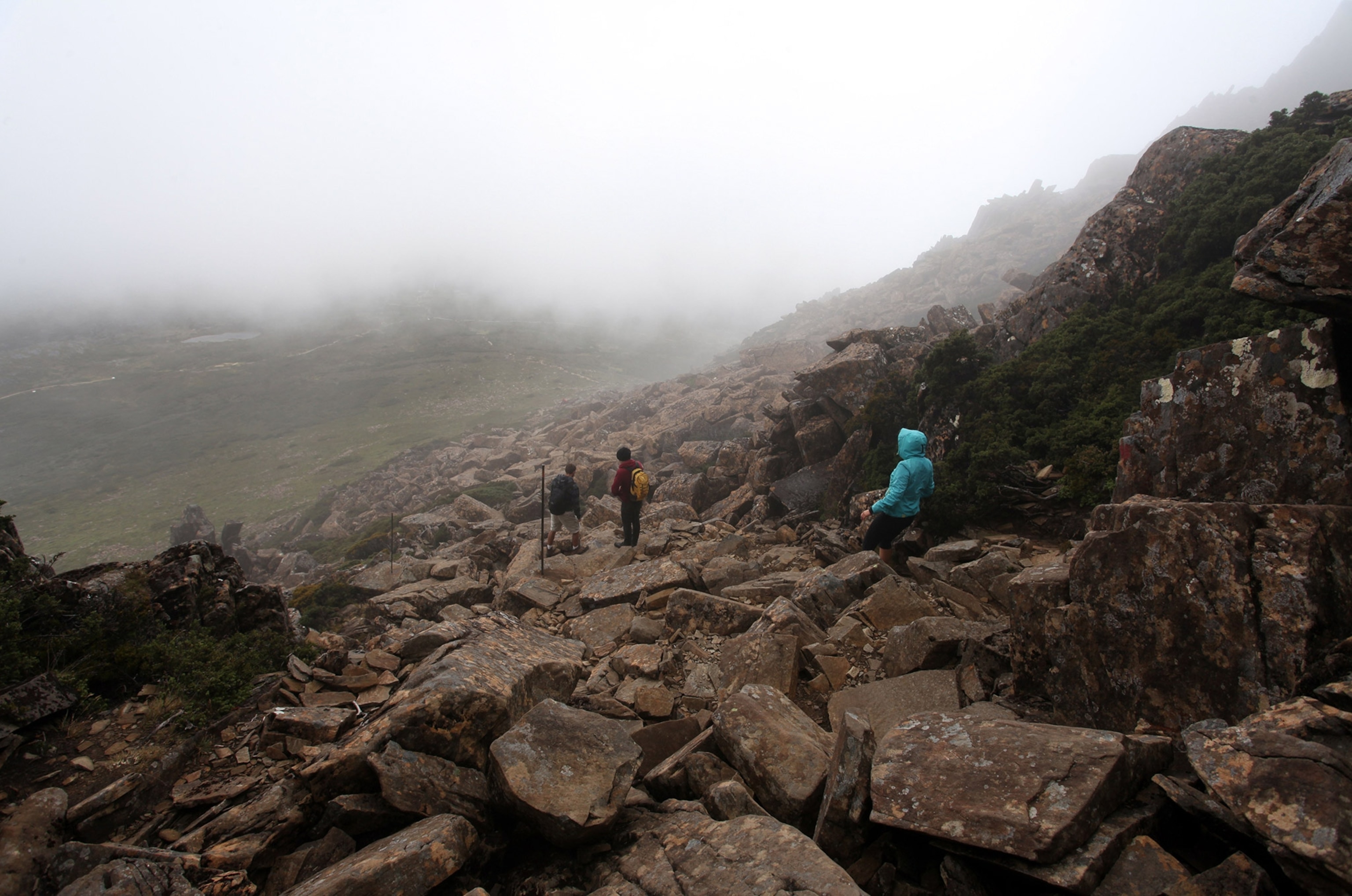 hikers descending from the summit of Cradle Mountain in Tasmania