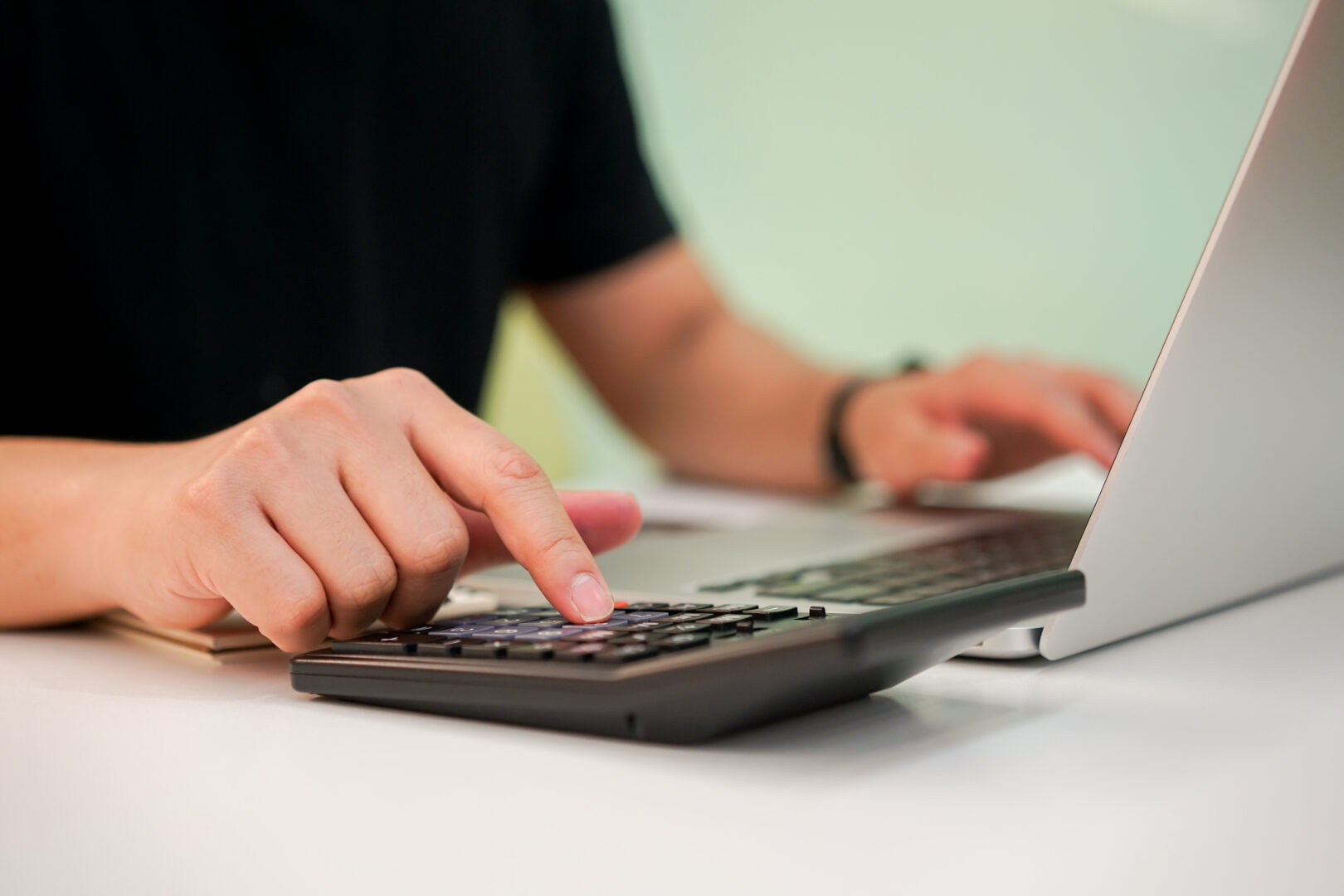 close-up-employee-man-finger-press-calculator-manage-expenses-concept