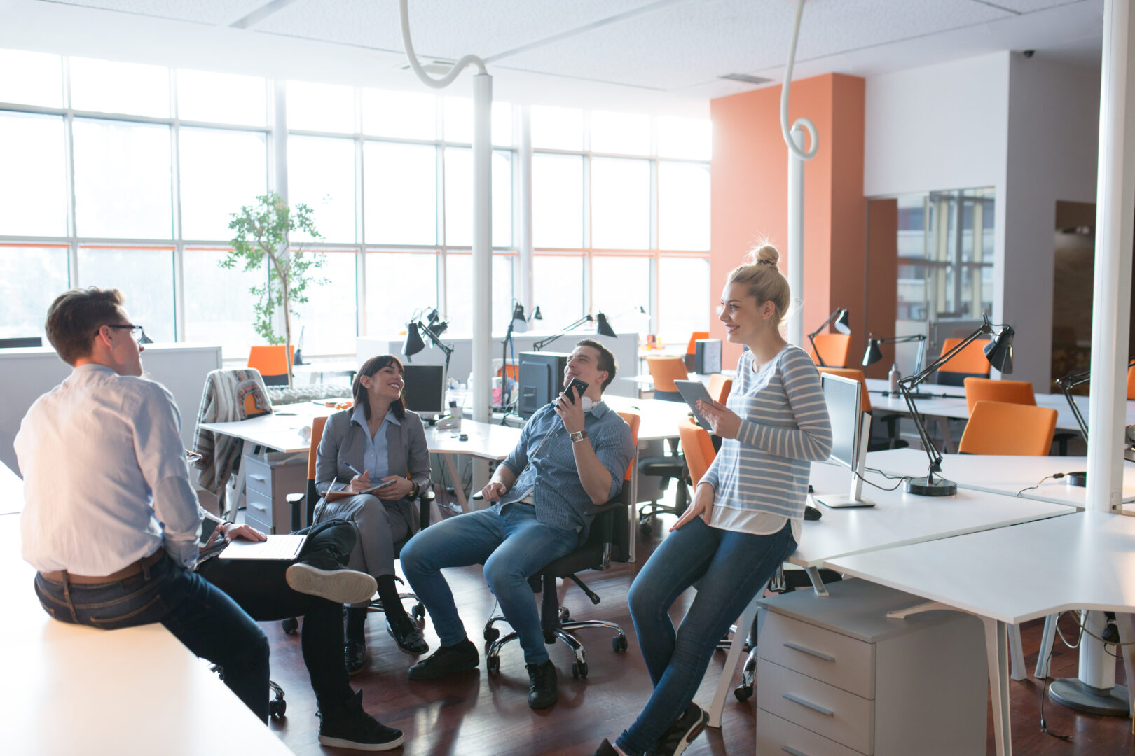 Group of a young business people discussing business plan in the office