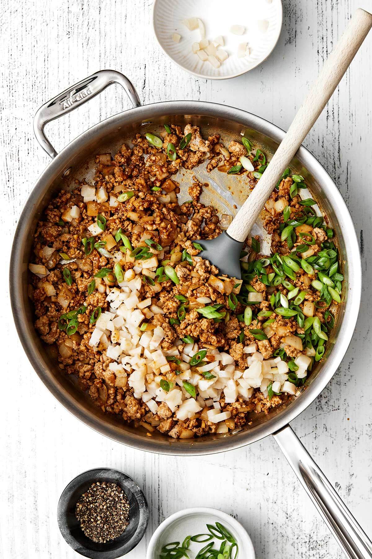 Cooked minced meat with vegetables in a pan.