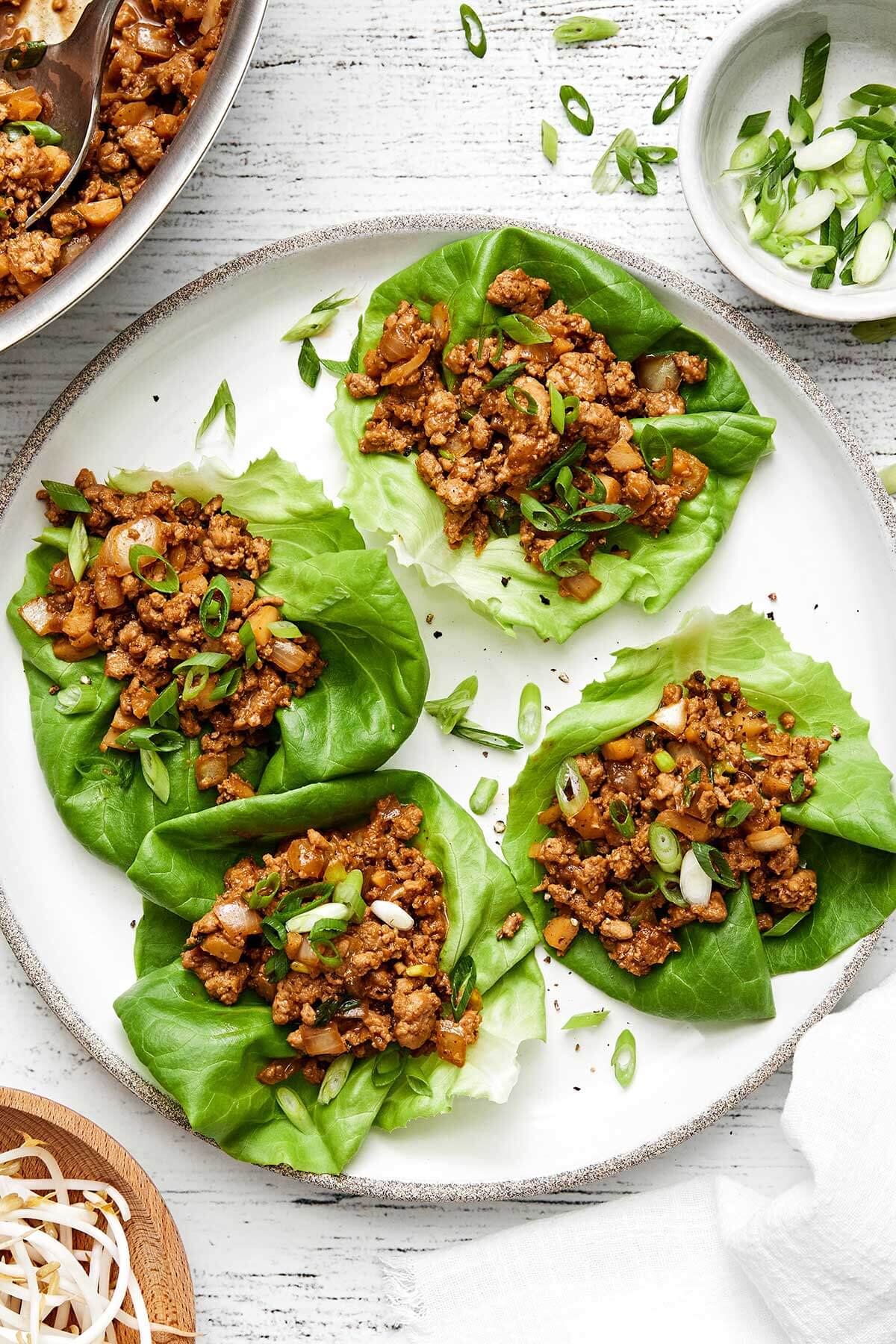 Asian chicken lettuce wraps on a plate.