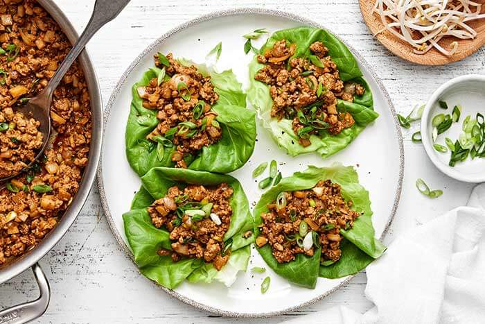 A plate of Asian chicken lettuce wraps.